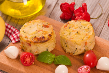 Potato gratins with mozzarella and tomatoes.