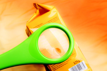 Empty magnifying glass on food additives label with copy space for your text. Concept reading...
