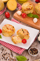 Potato gratins with mozzarella and tomatoes.
