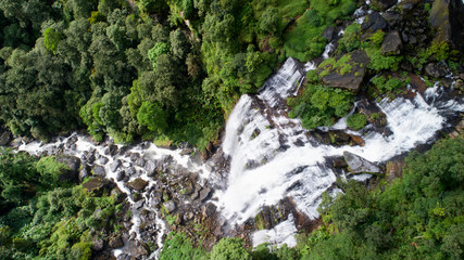 Beautiful waterfall.Tad Khamued Waterfall in southern Laos.It is a place to visit the natural beauty.Mountain forest fall landscape.Top view,Aerial view,waterfall amazing nature background,Rainfores