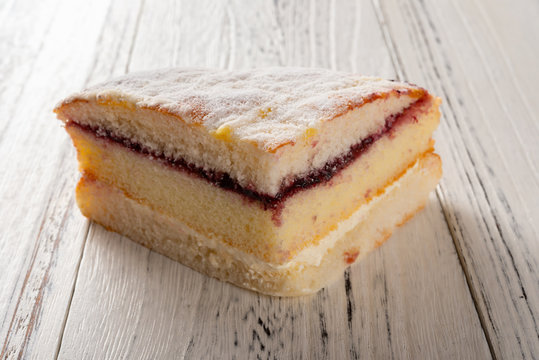multi-layer sponge cake on white wood background