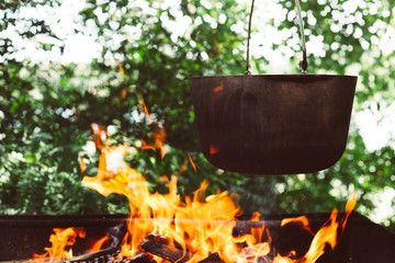 cooking in a pot on the fire in nature