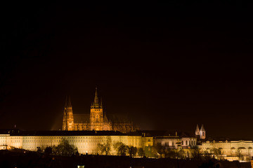 Prague Castle of Prague by night, with the saint Vitus gothic cathedral standing out against a very dark sky