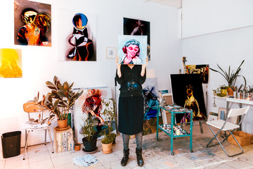 portrait of a female artist painter working in her studio atelier