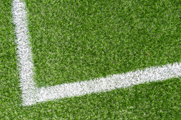 Green synthetic grass soccer sports field with white corner stripe line