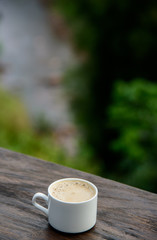 Hot latte on the beautiful nature background