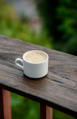 Hot latte on the beautiful nature background