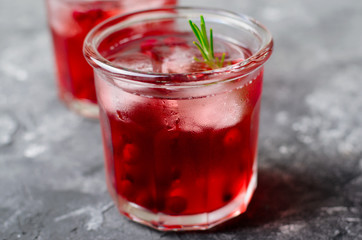 Cranberry Cocktail with Ice and Rosemary On Grey Background