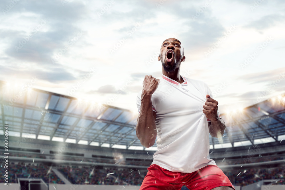 Wall mural the football african player in motion on the field of stadium at day. the professional football, soc