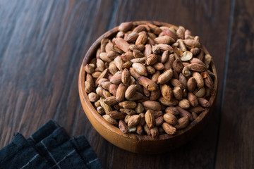 Organic Pistachio Nuts Without Shell in Wooden Bowl.