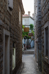 Narrow streets of the old stone town with stone blocks.