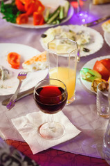 A glass of wine is on a served table. Festive banquet, Russia.