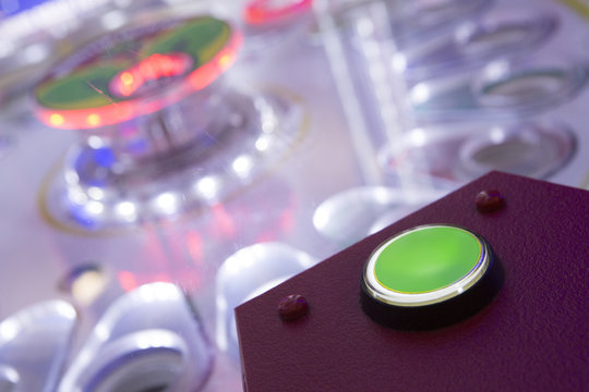 Close up of button on arcade machine