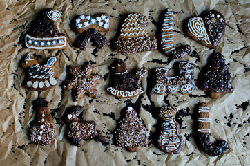 Flatlay christassy gingerbreads decoration on pergamin in brown, black white colours