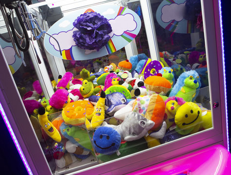 Close up of a crane claw machine with stuffed toys