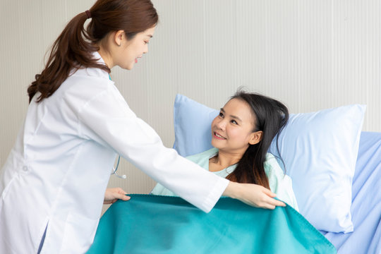 Asian Female Doctor Patient Care And Fabric Cover.