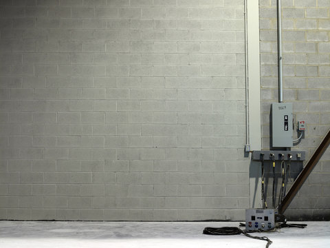Circuit breakers against a gray brick wall