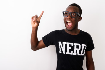 Studio shot of young happy black African geek man with great ide