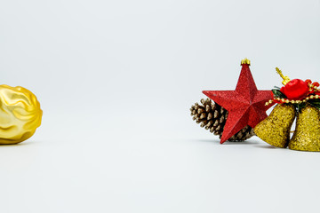 Cone pine, golden bells decorations, red star and christmas tree ball on white.