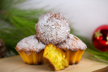Homemade cristmas cupcake, christmas muffins and new yaer decoration on the white background and pine branches and cones