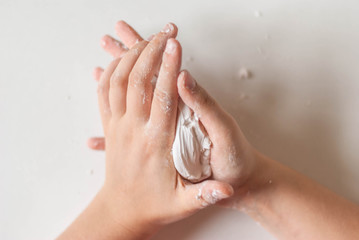 slightly blurred motion of young artist hands in the process of working with polymer clay on a...