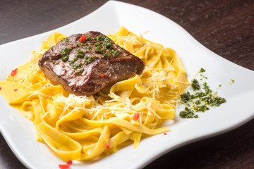 Peruvian food: Fetucinni with huancaina sauce and grilled beef.