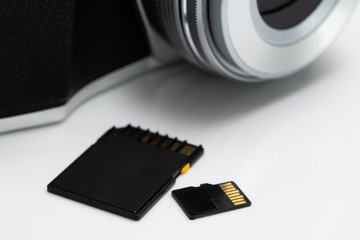 Micro and Normal SD Card memory besides a Mirrorless DSLR Camera