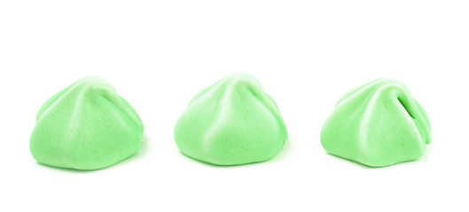 Line of Three Green Meringues on a White Background