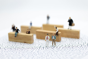 Miniature people : Businessmen are looking for a solution and teamwork. Image use for solve problems and new idea concept.