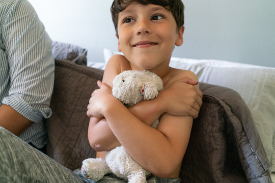 Boy Hugging Stuffed Animal at Bedtime