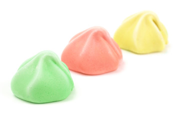 Line of Three Different Colored Meringues on a White Background