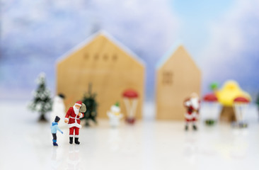 Miniature Santa Claus and children happy feeling on Christmas day, gift for everyone.