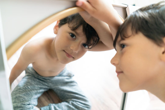 Boy looking at camera from mirror