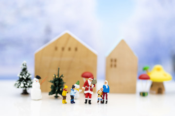 Miniature Santa Claus and children happy feeling on Christmas day, gift for everyone.