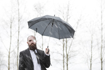 A bald bearded man in a suit