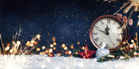 New Year's clock. Decorated with balls, star and tree on snow