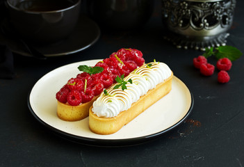 Lemon pie with meringue and raspberries.