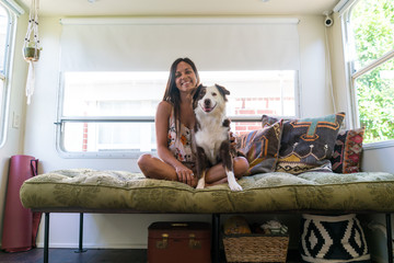 Woman sitting on sofa with Dogs