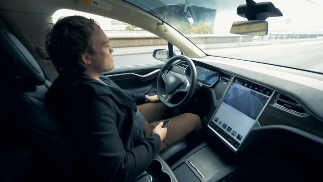 An electric car on a self-driving mode. Autonomous autopilot driverless car.