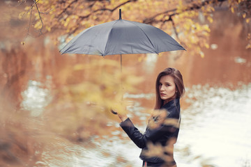 Young girl in autumn park