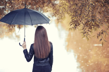 Young girl in autumn park