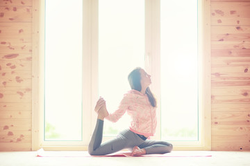 Girl in yoga poses on the floor