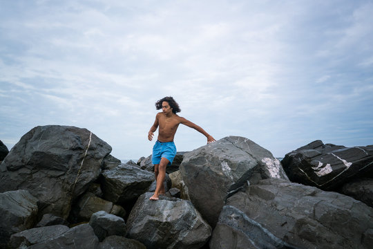 Boy Climbing on Bolders