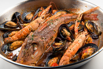 Pan with Tub gurnard prawn mussels olives and tomatoes