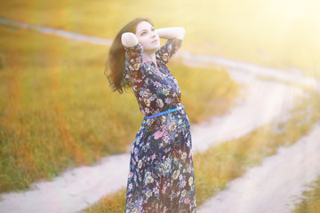 Pregnant girl in a dress in nature