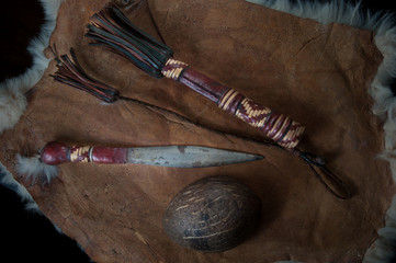 Old dagger, beautiful ritual knife, with a wooden scabbard decorated with leather. On leather