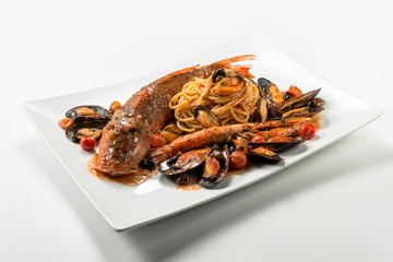 Plate of spaghetti with Tub gurnard prawn mussels olives and tomatoes