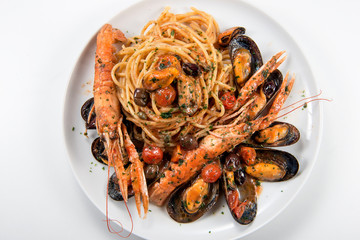 Plate of spaghetti with prawn mussels olives and tomatoes