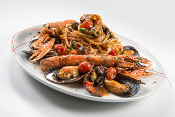 Plate of spaghetti with prawn mussels olives and tomatoes