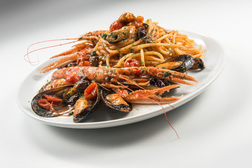 Plate of spaghetti with prawn mussels olives and tomatoes